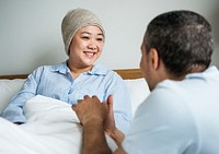 A sick woman in bed with her partner