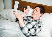 A woman video calling in bed