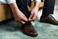 A man tying shoe lace