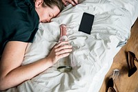 A drunk woman passing out in bed