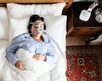 Woman sleeping with an anti-snoring mask