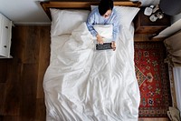 Woman in bed using a digital device