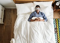 Guy wearing a mask sleeping in bed