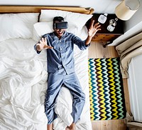 Man in bed using a VR headset
