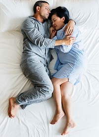 Interracial couple sleeping together on the bed