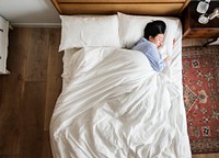 Asian woman on the bed sleeping by herself