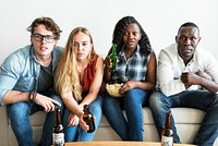 Group of diverse friends watching sports together seriously