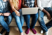 Group of diverse friends hanging out and using digital devices