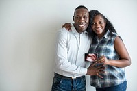 Black couple with a baby ultrasound photo