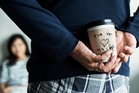 Romantic asian man brings a cup of coffee for wife