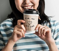 Closeup of Asian woman holding coffee cup