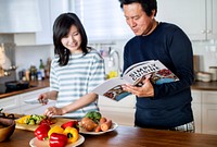 Asian couple cooking in the kitchen