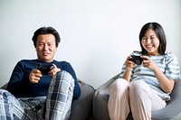 Asian couple playing video game