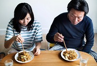 Asian couple eating noodles