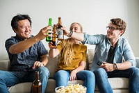Group of diverse friends having a movie night drinking beer