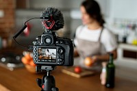 Female vlogger recording cooking related broadcast at home