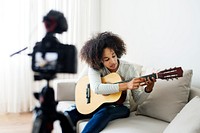 Female vlogger recording music related broadcast at home