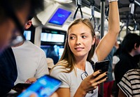 Young woman using a smartphone in the subway