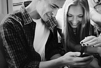 Group of young adult friends using smartphones in the subway