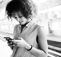 Young woman using a smartphone on the subway station