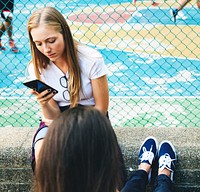 Friends in the park using smartphones