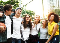 Smiling happy young adult friends arms around shoulder outdoors friendship and connection concept