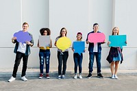 Young adult friends holding up copyspace placard thought bubbles