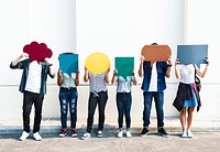 Young adult friends holding up copyspace placard thought bubbles