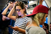 Young woman using a smartphone on the subway