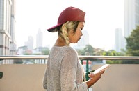 Young woman using a smartphone in the cityscape