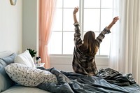 Rear view of woman stretching her arms in the morning