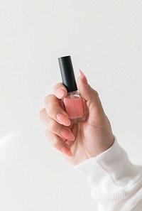 Closeup of hand holding nail polish bottle
