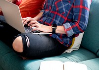 Caucasian woman using a laptop on the couch
