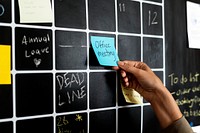 Closeup of hand pulling sticky note