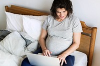 Pregnant woman using computer laptop