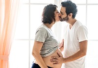 Pregnant woman and husband kissing