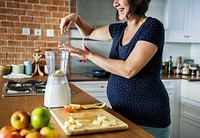 Pregnant woman making healthy smoothie