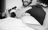 Man playing guitar for pregnant wife