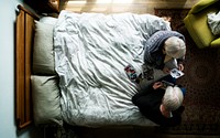 Elderly Caucasian sitting on the bed talking