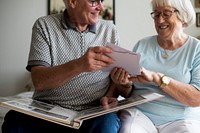 Senior couple looking at family photo album