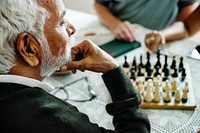 Senior friends playing chess together