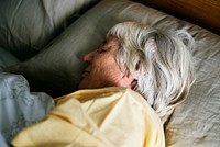 Elderly caucasian woman sleeping on the bed