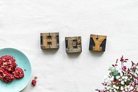 Antique grunge letter cube spelling hey greeting concept