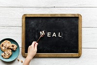 Aerial view of black board with the word meal
