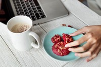 Woman using a computer laptop and having a snack break