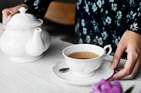 Woman helping herself with a cup of nice hot tea