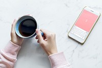 Aerial view of woman with a hot cup of coffee and a smartphone