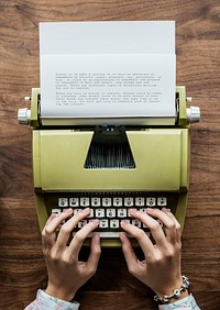 Aerial view a woman using a retro typewriter
