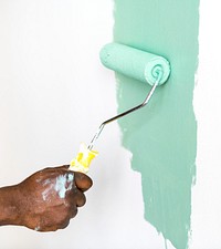 People painting house wall