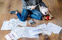 Sorting out a pile of bills on the floor